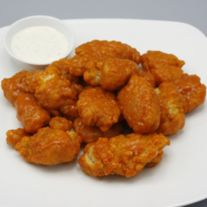 Boneless chicken wings with a side of ranch and blue cheese dressing.