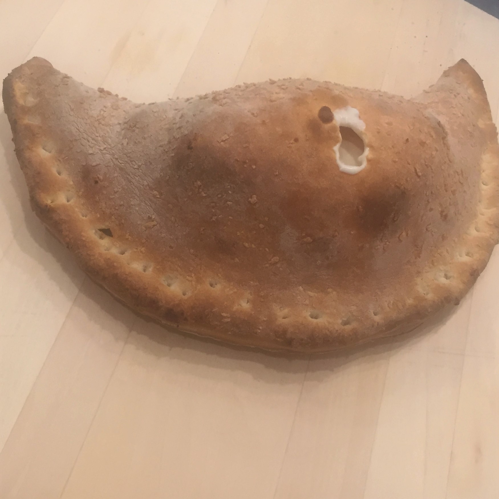 Customizable cheese calzone with various toppings and premium add-ons.