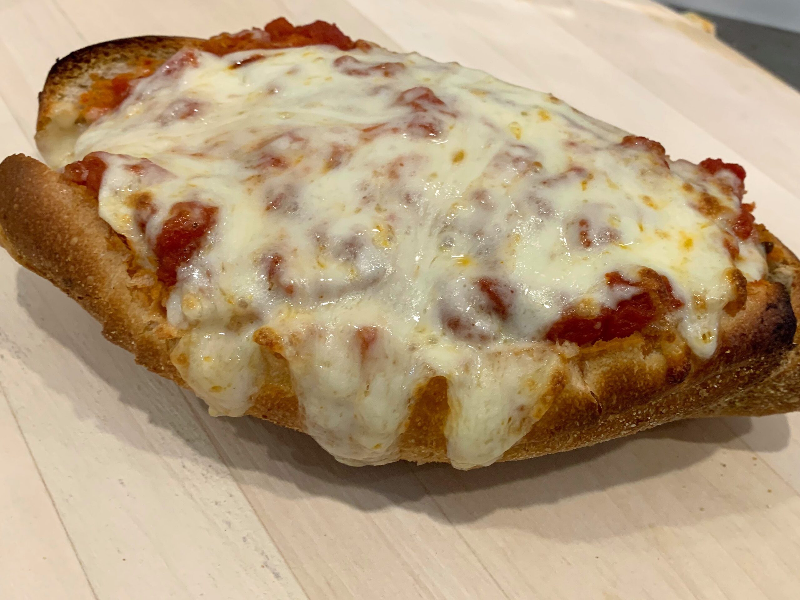 Homemade Meatball alla Parmigiana Hero with marinara sauce and melted mozzarella cheese on a freshly baked roll.
