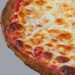 Gluten-free pizza topped with fresh tomatoes, homemade marinara sauce, fresh basil leaves, and melted aged mozzarella on a crispy gluten-free crust."