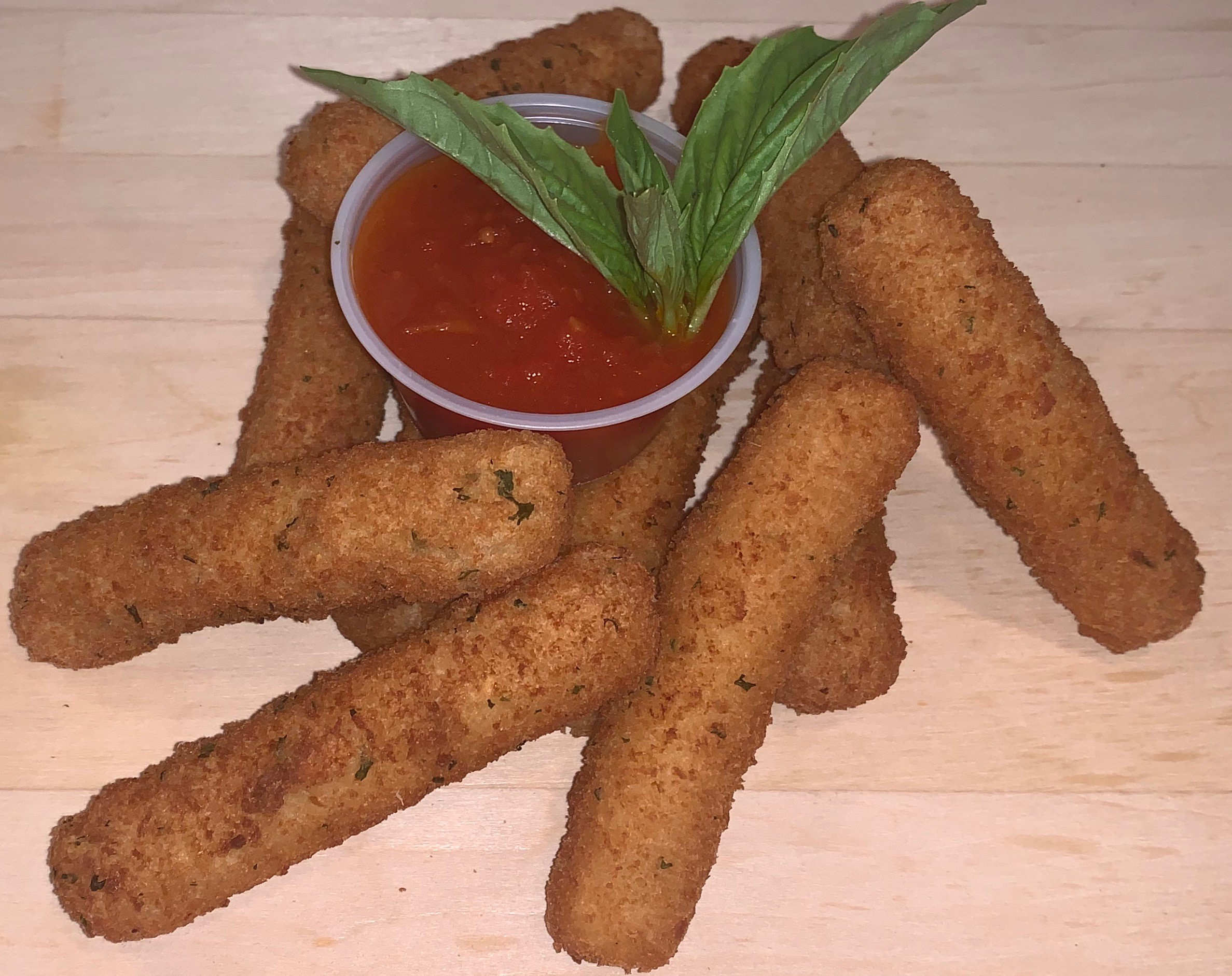 Mozzarella sticks with a side of marinara sauce.