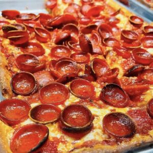 A Spicy Pepperoni Pie with homemade marinara sauce, fresh aged mozzarella, rosemary, and quality pepperoni, drizzled with cold-pressed virgin olive oil.