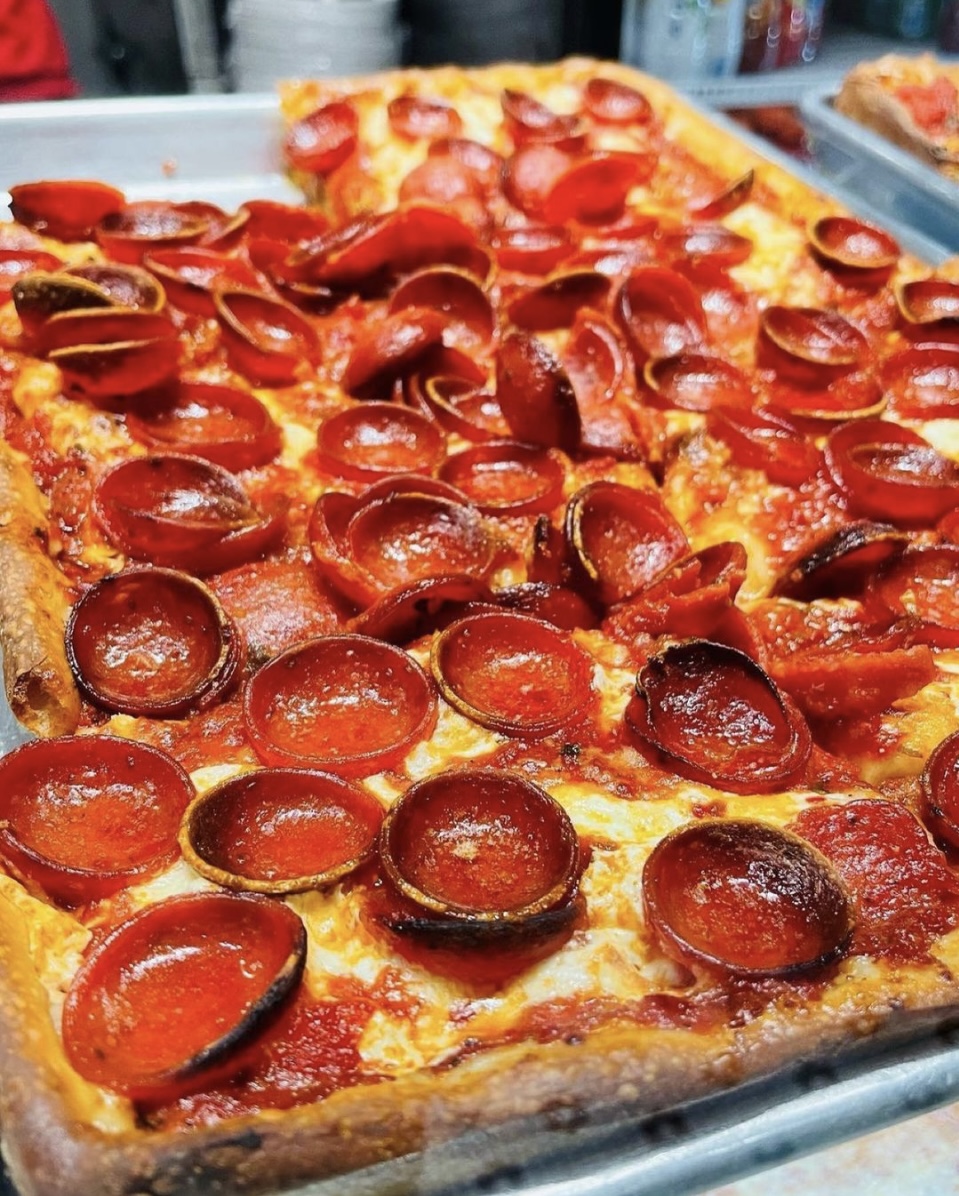 A Spicy Pepperoni Pie with homemade marinara sauce, fresh aged mozzarella, rosemary, and quality pepperoni, drizzled with cold-pressed virgin olive oil.