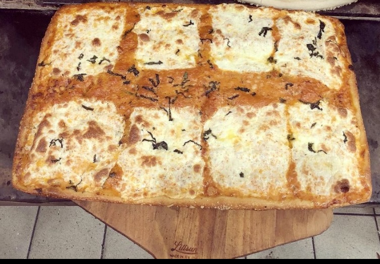 A Vodka Pie with fresh mozzarella, rich vodka sauce, and a sprinkle of parmesan.