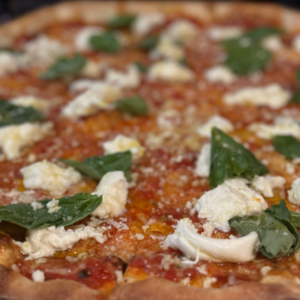 Burrata pizza with creamy imported burrata cheese, San Marzano marinara sauce, fresh basil, Parmigiano Reggiano, and a drizzle of olive oil.